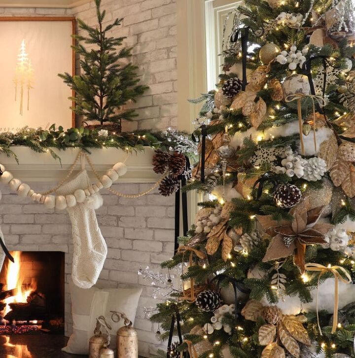 6 easy ways to achieve an irresistibly festive white christmas tree, Christmas tree with added bits of snow for decor next to the fire with stockings hung