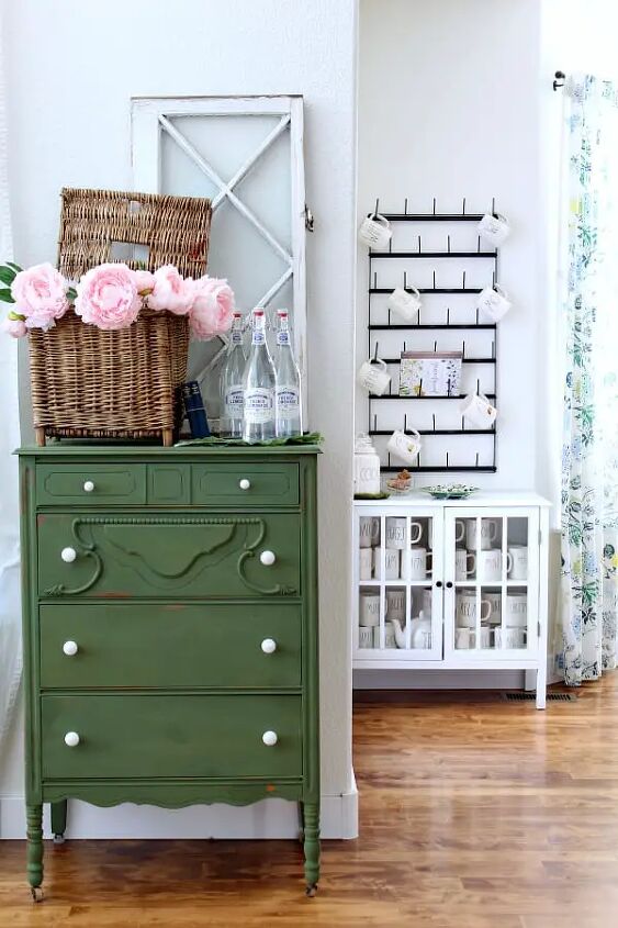 how to use baskets when decorating your home, Mugs for days and a green painted dresser give this cottage kitchen a colorful nod to Spring
