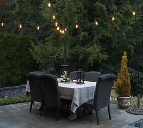 how to make your backyard special with outdoor lighting, beautiful outdoor patio setting with string lights and dining table