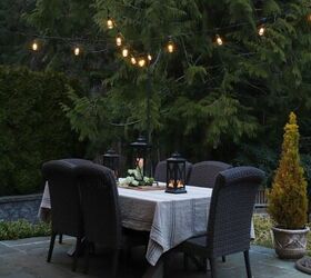 how to make your backyard special with outdoor lighting, outdoor dining table with overhead string lights adds the perfect amount of mood lighting