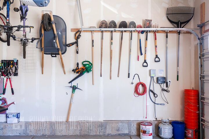 the best tips to an organized and functional garage, Organized garage Inexpensive storage hooks are mounted to a 2x4 on the garage wall to store shovels rakes and other garden tools Wheel barrow is mounted to hook and stored on the wall too