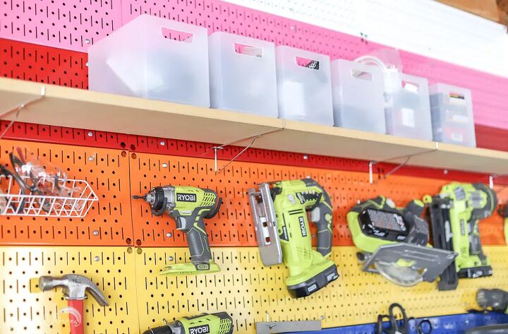the best tips to an organized and functional garage, Colorful wall storage with Wall Control laid out in a rainbow pattern with plastic bins on shelf and lower tools hung on the wall
