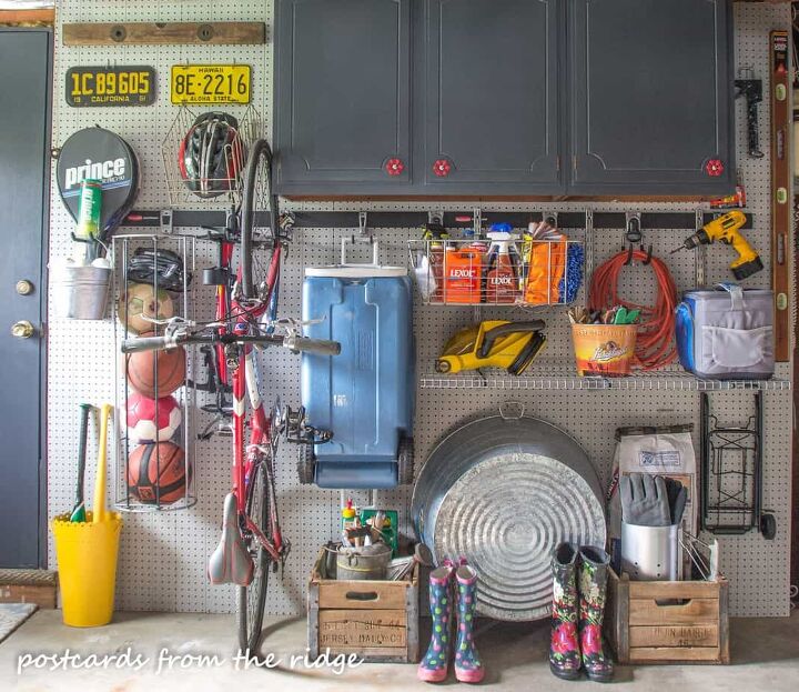 the best tips to an organized and functional garage, Pegboard wall organizing sports equipment balls bats tennis rackets bike cooler power tools extension cord boots and closed cabinet storage