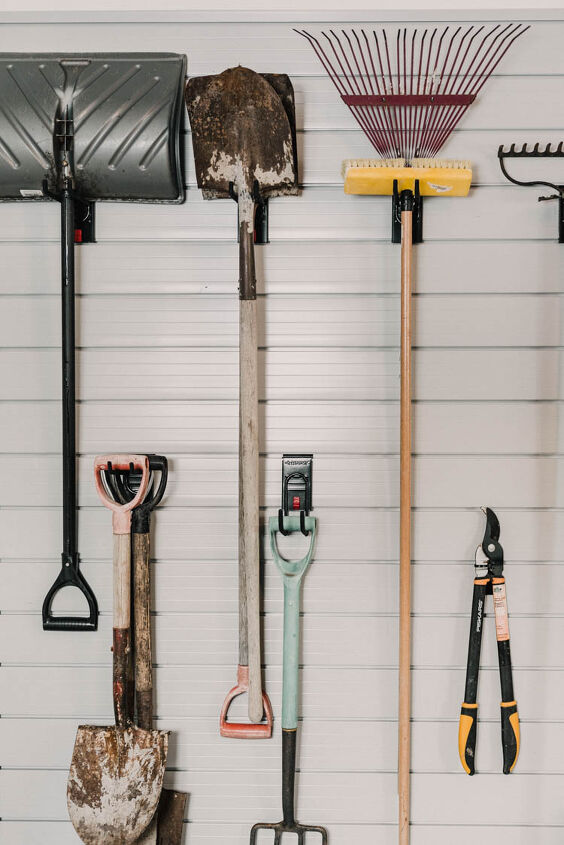 the best tips to an organized and functional garage, Organized garage ideas slat wall storage for shovels takes pruners etc