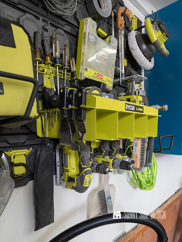 the best tips to an organized and functional garage, Vertical storage on the garage wall with the Ryobi Links tool organizer Holds power tools like drills saws router and the battery packs and chargers Storage also for extension cords screw drivers hammers chisels saws etc