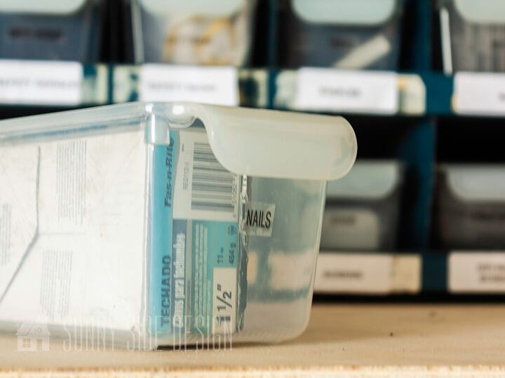 the best tips to an organized and functional garage, Storage container from the dollar store is labeled and holds nails with the organizer cubby in the background