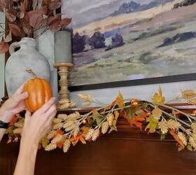 Adding pumpkins to the mantel