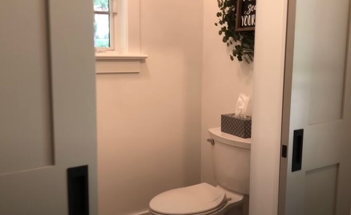 Half bath with a utility sink and shiplap wall