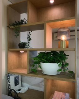 how to make a small home feel bigger, Adding puck lights to shelves
