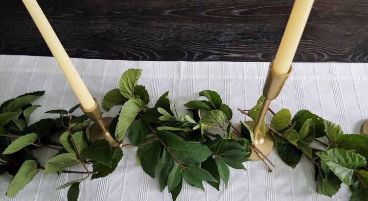 Weaving greenery around candles and candle holders