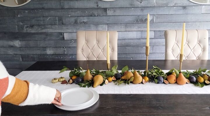 Placing dinnerware on the Thanksgiving tablescape