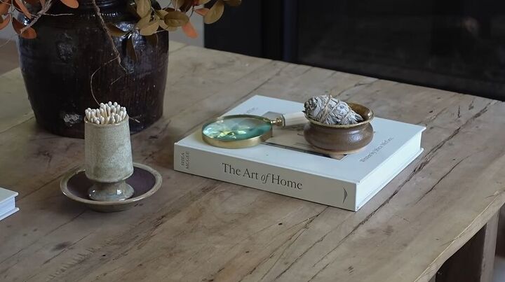 Styling a coffee table with sage and a magnifying glass