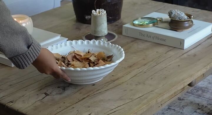 how to style a coffee table, Adding a bowl with leaves to the coffee table