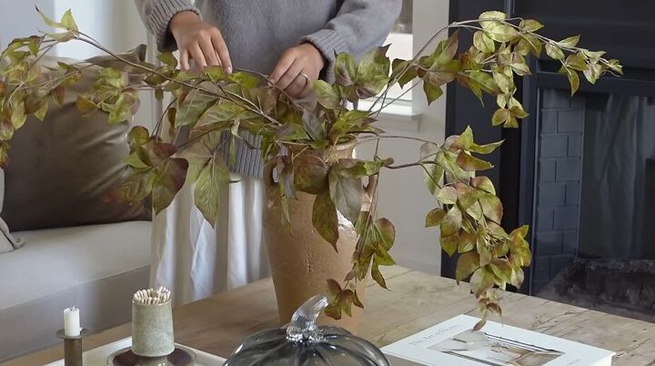 how to style a coffee table, Grape ivy branches in a pot