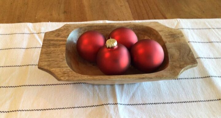 Adding red ornaments to a dough bowl