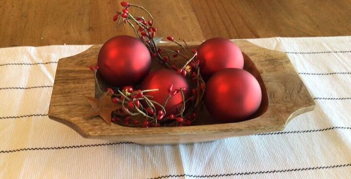 Red berries and ornaments in a small dough bowl