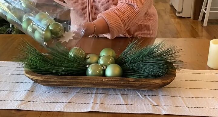 Adding green ornaments to the dough bowl