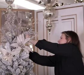 Adding white poinsettias to the tree