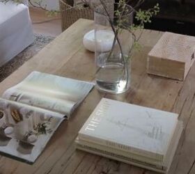 Coffee table styled with an open book and vase of fresh flowers