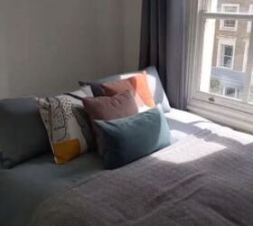 quirky design, Bed by the window with layered pillows