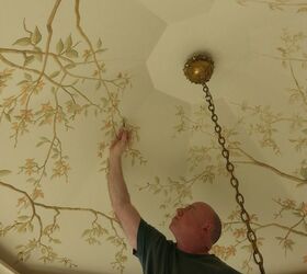 Someone hand-painting a ceiling mural