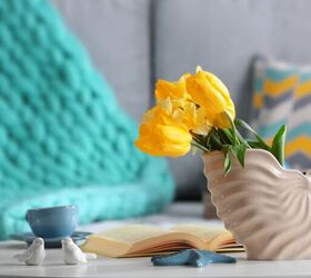 top 3 trending home dcor and art pieces, Shell vase with yellow flowers image via Canva