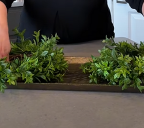 Lay 3 small boxwood wreaths on a long tray to create something stunning for your table